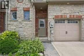 Guelph townhouse for rent - A house with a stone facade and a brown door.