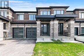 Kawartha Lakes (Lindsay) townhouse for rent - A modern house with a large front yard and a car parked in the driveway.