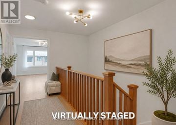 Kawartha Lakes (Lindsay) townhouse for rent - A virtual staged living room with a painting on the wall and a plant on the side table.