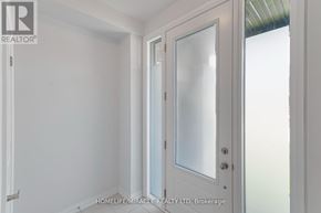 Kawartha Lakes (Lindsay) townhouse for rent - A white door with a glass panel is in a room with white walls.