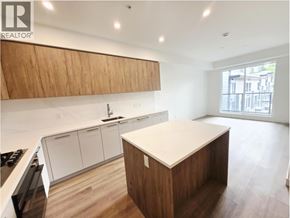 Coquitlam apartment for rent - A kitchen with a wooden island and white cabinets.