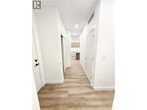 Coquitlam apartment for rent - A hallway with white walls and a carpeted floor.