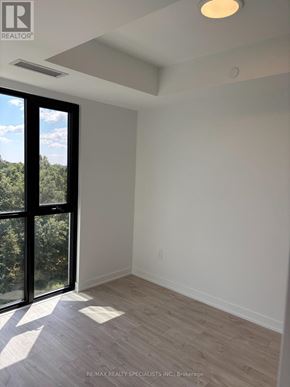 Milton (Cb Cobban) condo for rent - A room with a sliding glass door leading to a tree-filled landscape.