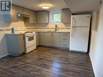 Toronto (Maple Leaf) apartment for rent - A kitchen with a white fridge, stove and cabinets.