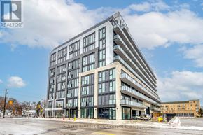 Toronto (Stonegate-Queensway) condo for rent - A large, modern building with many windows is the focal point of the image.