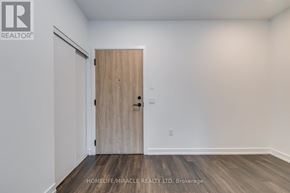 Toronto (Stonegate-Queensway) condo for rent - A room with a wooden door and a white wall.