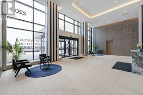 Mississauga (Port Credit) condo for rent - A modern office lobby with a reception desk and a large glass wall.