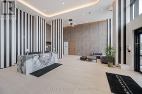 Mississauga (Port Credit) condo for rent - A reception area with a marble counter and striped walls.