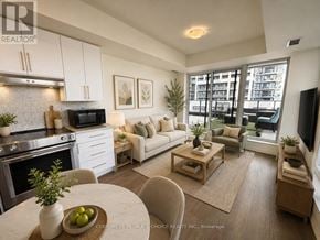 Vaughan (Concord) condo for rent - A modern kitchen with a dining table and chairs.
