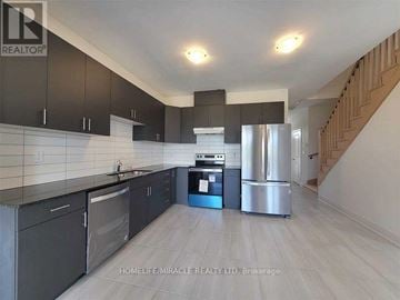 Zorra (Thamesford) townhouse for rent - A kitchen with dark cabinets and stainless steel appliances.