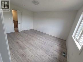 Zorra (Thamesford) townhouse for rent - A room with wooden flooring and white walls.
