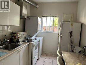 Richmond apartment for rent - A kitchen with a sink, stove, and refrigerator.