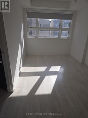 Burlington (Lasalle) townhouse for rent - A sunny room with a window and wooden floors.