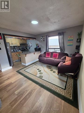 Toronto (Malvern) apartment for rent - A living room with a purple couch and a rug.