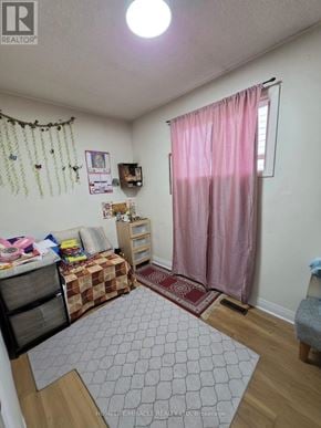 Toronto (Malvern) apartment for rent - A bedroom with a pink curtain and a grey rug.