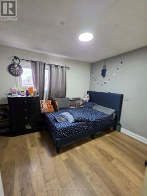 Toronto (Malvern) apartment for rent - A bedroom with a bed, dresser, and window.