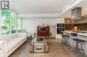 North Vancouver townhouse for rent - A modern kitchen with a white sofa and a wooden cabinet.
