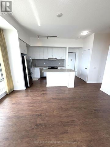 Mississauga (Central Erin Mills) condo for rent - A kitchen with white cabinets and a wooden floor.