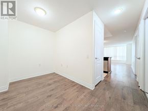 Toronto (Willowdale East) condo for rent - A room with wooden flooring and white walls.