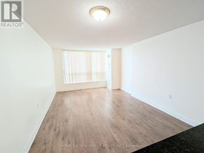Toronto (Willowdale East) condo for rent - A room with wooden flooring and white walls, with a window covered by white blinds.