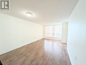 Toronto (Willowdale East) condo for rent - A room with wooden flooring and a window with blinds.