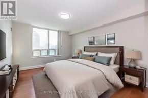 Toronto (Woburn) condo for rent - A bedroom with a large bed and a window.
