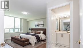 Toronto (Woburn) condo for rent - A bedroom with a large bed and a small bathroom with a mirror.