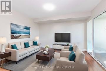 Toronto (Woburn) condo for rent - A living room with a white couch, a coffee table, and a painting on the wall.