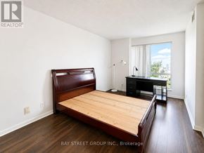 Toronto (Woburn) condo for rent - A bedroom with a bed, desk, and chair.
