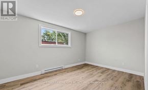 London South (South J) multi-family for rent - A room with a window and a picture on the wall.