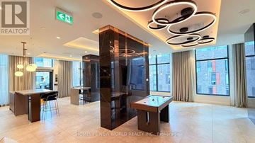 Toronto (Church-Yonge Corridor) condo for rent - A well-lit, modern living room with a pool table and a bar area.
