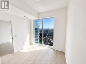 Toronto (Church-Yonge Corridor) condo for rent - A room with a view of the city through a large window.