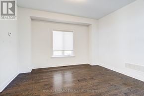 New Tecumseth (Alliston) apartment for rent - A room with a window and wooden flooring.