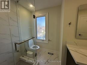Mississauga (Erin Mills) apartment for rent - A bathroom with a toilet, sink, and window.