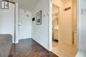 Toronto (Cabbagetown-South St. James Town) condo for rent - A bedroom with a bed and a mirror on the wall.