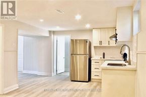 Toronto (Islington-City Centre West) apartment for rent - A kitchen with a refrigerator, sink, and cabinets.