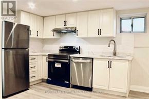 Toronto (Islington-City Centre West) apartment for rent - A kitchen with white cabinets and a stainless steel refrigerator.