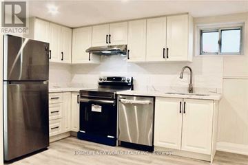 Toronto (Islington-City Centre West) apartment for rent - A kitchen with white cabinets and a stainless steel refrigerator.