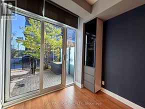 Toronto (Islington-City Centre West) condo for rent - A glass door leading to a patio with a tree outside.