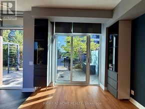 Toronto (Islington-City Centre West) condo for rent - A room with a sliding glass door leading to a backyard.