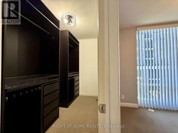 Toronto (Islington-City Centre West) condo for rent - A well lit kitchen with a black counter top.
