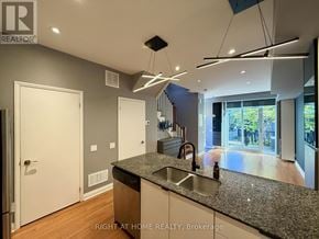 Toronto (Islington-City Centre West) condo for rent - A modern kitchen with granite countertops and stainless steel appliances.