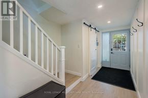 Mississauga (Meadowvale) townhouse for rent - A hallway with a staircase and a door leading to a balcony.