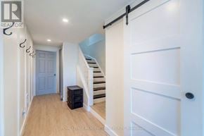 Mississauga (Meadowvale) townhouse for rent - A hallway with a staircase and a white door.
