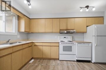 London North (North K) apartment for rent - A kitchen with wooden cabinets and white appliances.