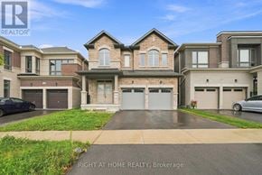 Oshawa (Kedron) apartment for rent - A large, multi-level house with a driveway in front.