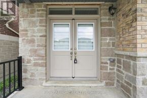 Oshawa (Kedron) apartment for rent - A double door with a glass window and a black handle.