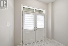 Oshawa (Kedron) apartment for rent - A white door with a window above it in a room.