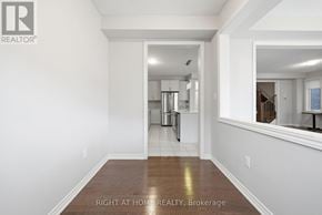 Oshawa (Kedron) apartment for rent - A white room with a wooden floor and a mirror on the wall.