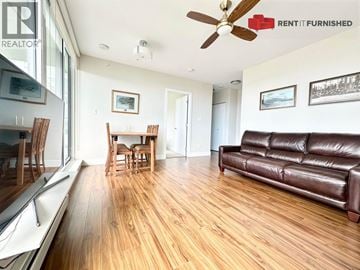 Vancouver apartment for rent - A living room with a brown leather couch and wooden floors.